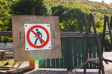 pedestrian traffic is prohibited on a black iron fence. ban on the passage of people and the sign movement is prohibited. Warning sign passage is forbidden