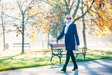 Middle-aged woman walking in city park