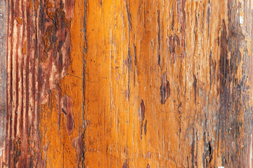 Peeling orange paint of old brown wood desk. scratched wooden flooring with lacquer peeled off&ndash; background for design.