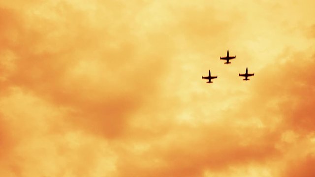 Armed russian fighter jets on the red sunset background