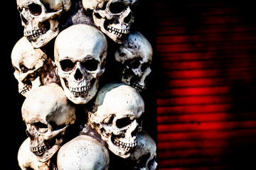 Gloomy skulls on a dark background. Skulls stand on top of each other.
