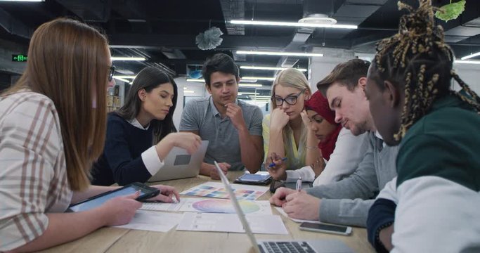 Young multiethnic business team of software developers working together using