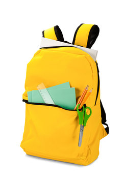 Backpack with different school stationery. Isolated on white background. Back to school concept photo.