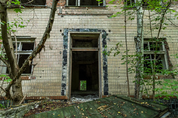 Old abandoned two-story house. Entrance to an abandoned house.