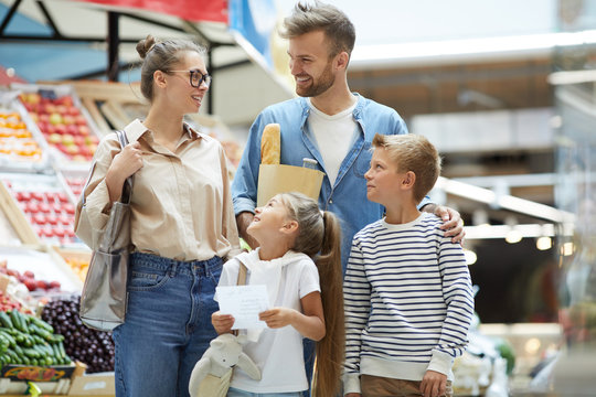 Portrait Of Contemporary Family With Two Kids Shopping At Farmers Market, Copy Space