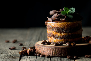 Chocolate cakes on black slatter board with mint, coffee beans on dark background, closeup photo. Fresh, tasty dessert food concept. - Powered by Adobe
