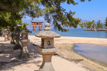 Itsukushima Floating Torii Gate located in Miyajima Island, Japan.  Japanese characters on the gate's plate translate as "itsukushima shrine".