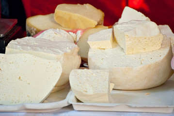 Different types of cheese on the table. Many cheese is sold at an agricultural fair. Natural home product.