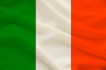national flag of the country ireland on delicate silk with wind folds, travel concept, immigration, politics, copy space, close-up