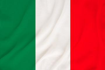 The national flag of the country of Italy on gentle silk with wind folds, travel concept, immigration, politics, copy space, close-up