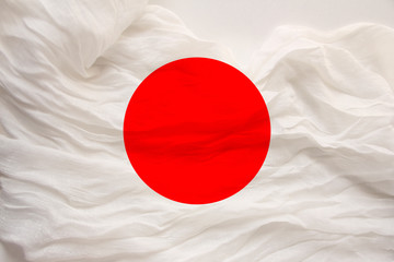 national flag of the country japan on gentle silk with wind folds, travel concept, immigration, politics, copy space, close-up