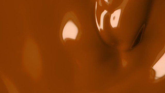 Super Slow Motion Shot of Swirling Brown Fluid Background at 1000fps. Shooted with High Speed Cinema Camera at 4K.