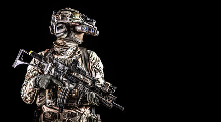Soldier in night vision device on black background