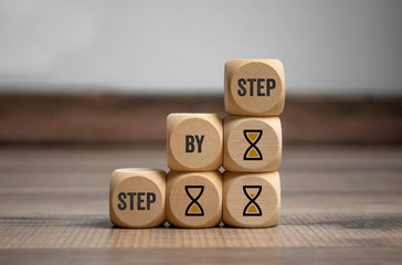 Cubes and dice with step by step on wooden background