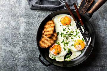 fried eggs in a cast iron pan top view