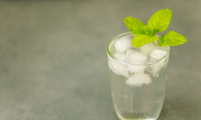 Delicious cold drink. Glass with ice cubes. Fresh icy cold cool freshening liquid. Beautiful...