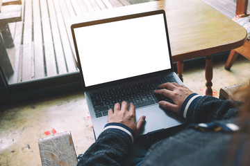 Mockup image of a woman using and typing on laptop keyboard with blank white desktop screen