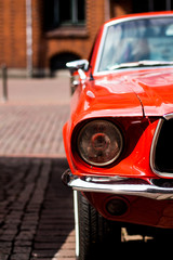 Closeup of a red classic Mustang parked in downtown Hannover, Germany