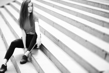 Obraz premium A girl posing on the steps of a building