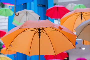 Fototapeta na wymiar used multi-colored open umbrellas for decoration
