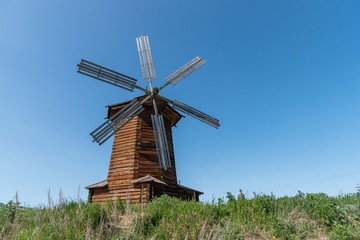 Old wooden windmill in a field