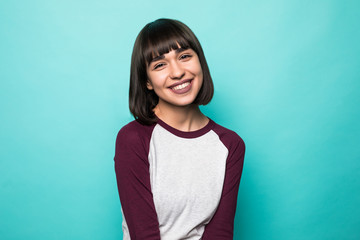 Portrait of beautiful cheerful smiling young woman on blue background