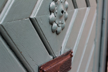 Detailed closeup of ancient wooden door with brass