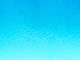 Blue background of water in swimming pool.
