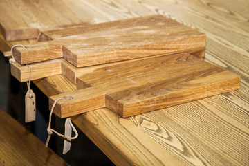 pile of wooden cutting boards on kitchen table
