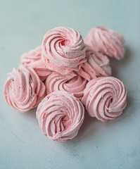 Meringue zephyr marshmallows on a light background. Pink sweet homemade marshmallow. meringue on white background.