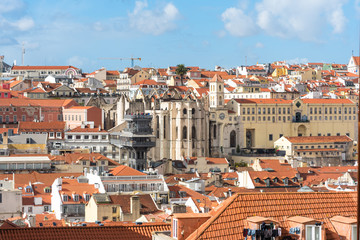 Fototapeta na wymiar The roofs of the Baixa district with Lisbon historic elevator de Santa Justa and the Igreja do Carmo