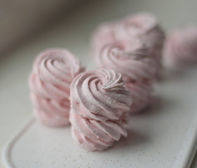 Meringue zephyr marshmallows on a light background. Pink sweet homemade marshmallow. meringue on white background.