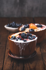 Granola, oatmeal with milk, peach and blue berry