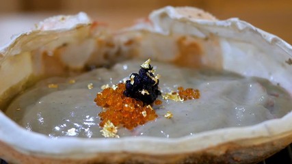 Zoom in of Kani Miso, crab miso, crab fat boiling / grill on the stove at the restaurant (Japanese Food)