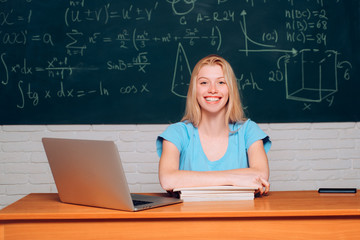 Science. Educational process. Student working on a laptop on some stairs on campus preparing for an exam. Teenage students with school notebook.