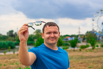 A young man with a smile suggests wearing glasses in order to improve your vision.