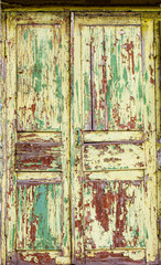 Texture with an old wooden painted and peeled door.