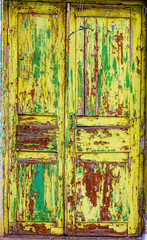 Texture with an old wooden painted and peeled door.