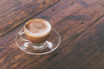 hot mocha coffee in glass coffe cup on old wooden desk