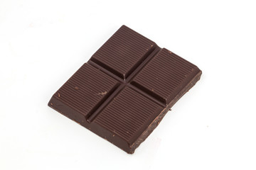 Dark chocolate pieces isolated on white background.