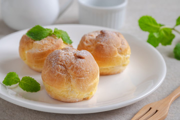 Cream puffs on white plate