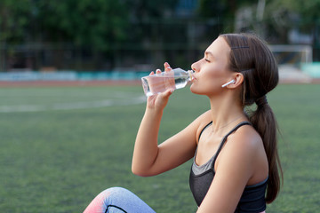 Sport girl drink water after training