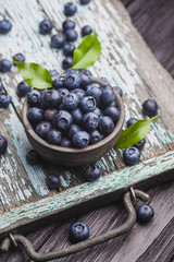 ripe blueberry berries on old wooden table. healthy food