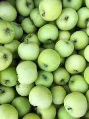 Delicious green apples in a box on the market