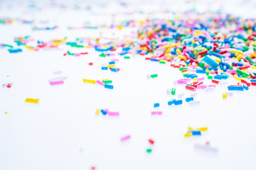 Colorful candy sprinkles close up for birthday cake on white background