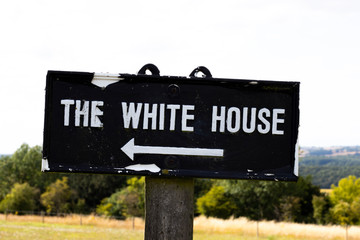 Obraz premium Dilapidated The White House sign in rural Hampshire, namesake of the official residence and workplace of the president of the United States of America