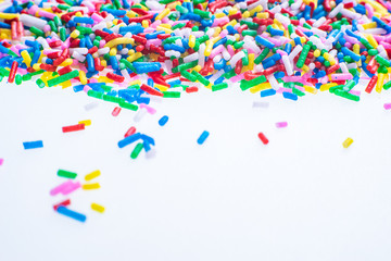 Colorful candy sprinkles close up for birthday cake on white background