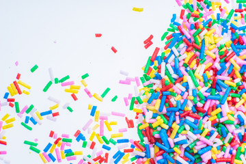 Colorful candy sprinkles close up for birthday cake on white background