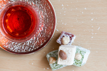 Traditional turkish delight and cup of tea. Top view