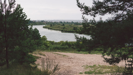 Large lake on a Sunny day against the background of a dense green forest, nature in Russia